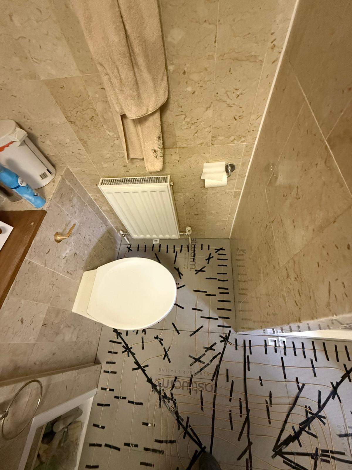 Underfloor heating fitted around the bathroom toilet area