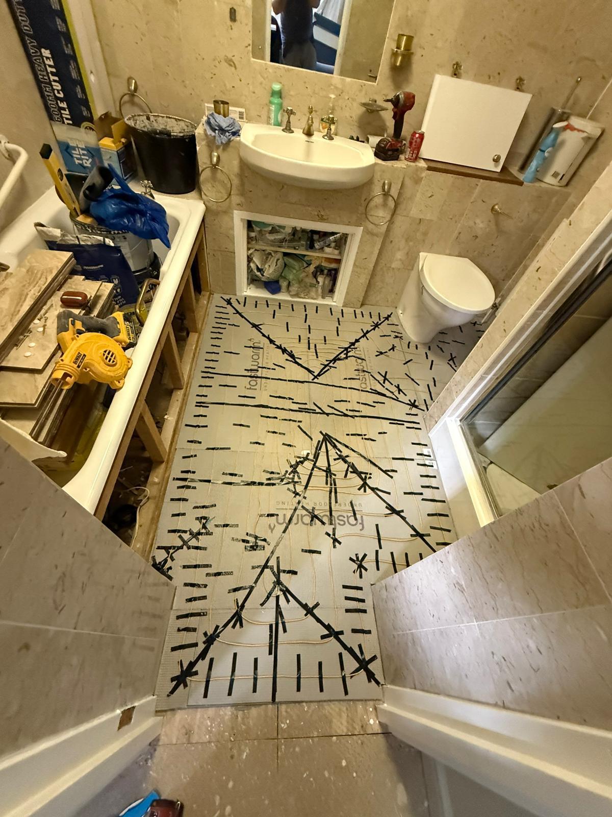 Underfloor heating mat installed across the bathroom floor