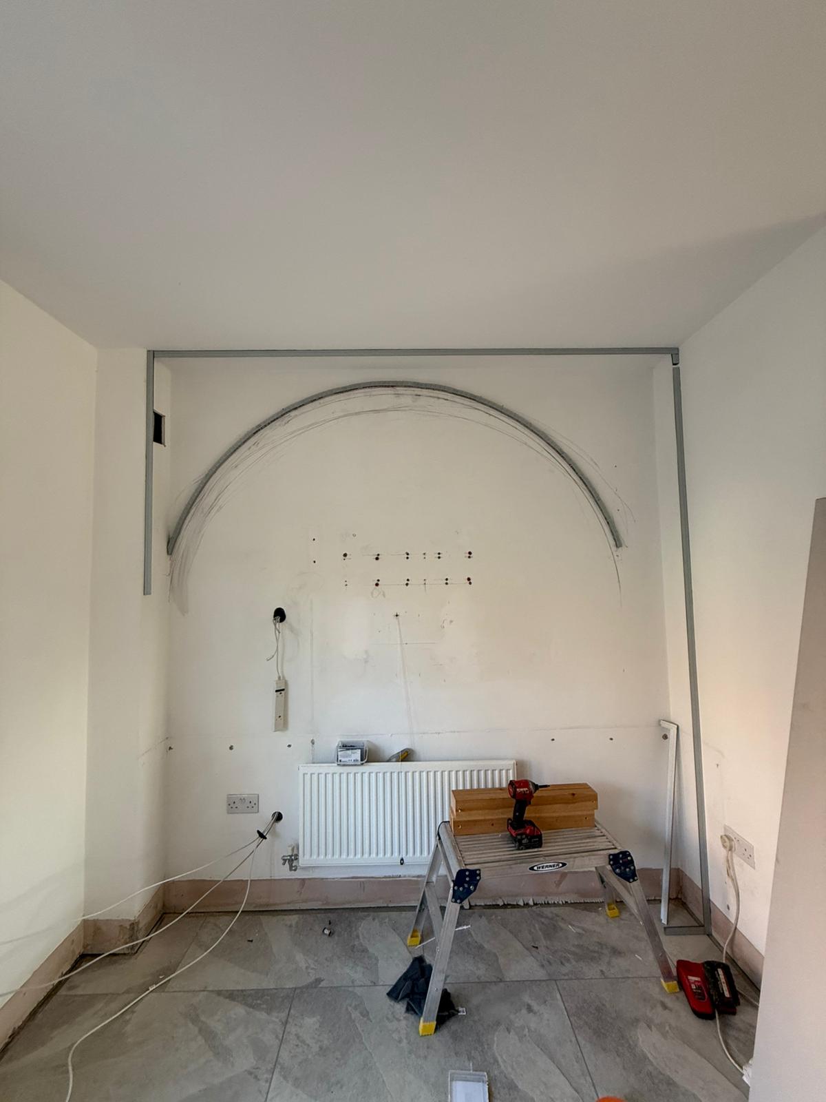 Custom arch set-out and framing marked on the wall
