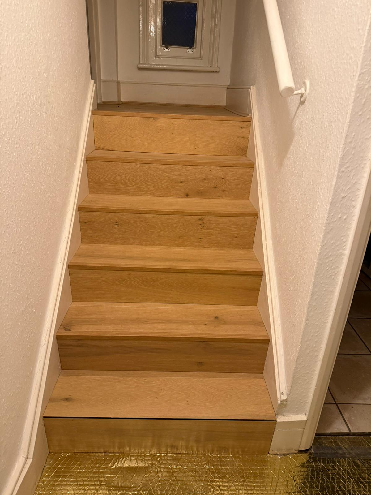 Staircase finished with matching engineered wood flooring
