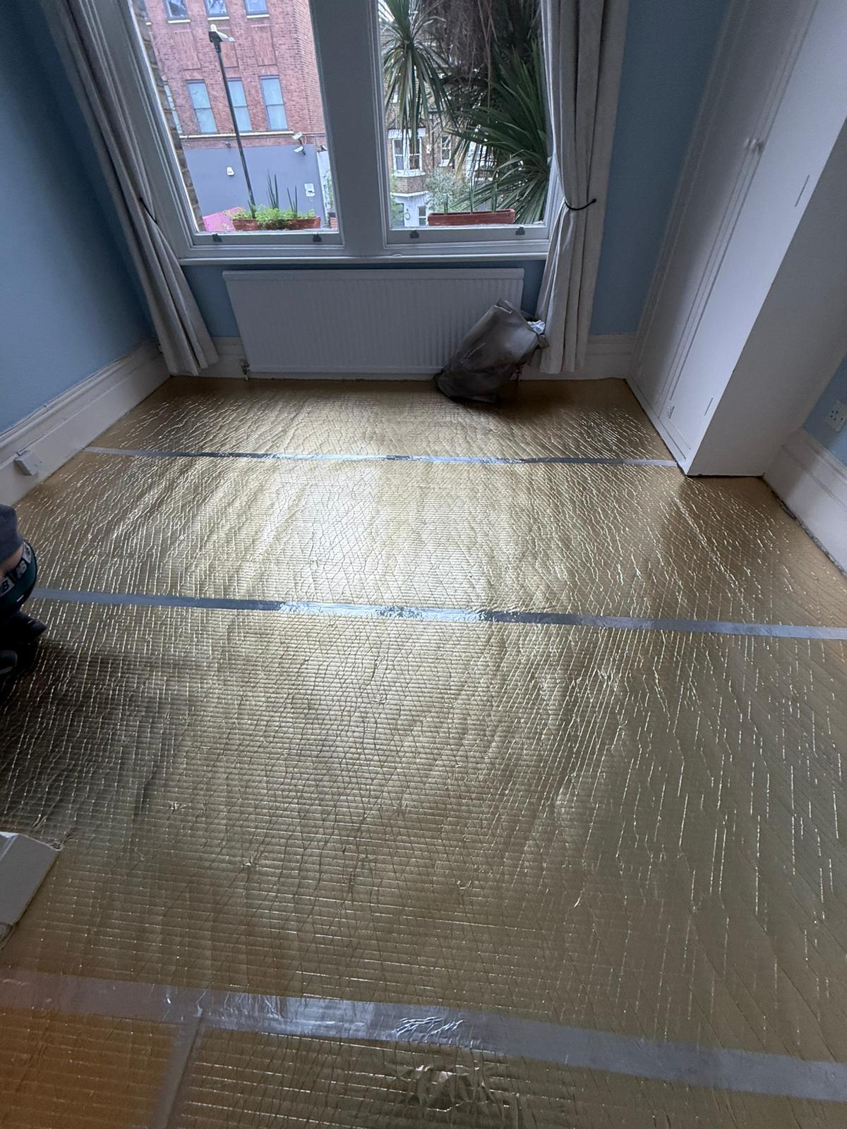 New insulating underlay and moisture membrane laid across the room