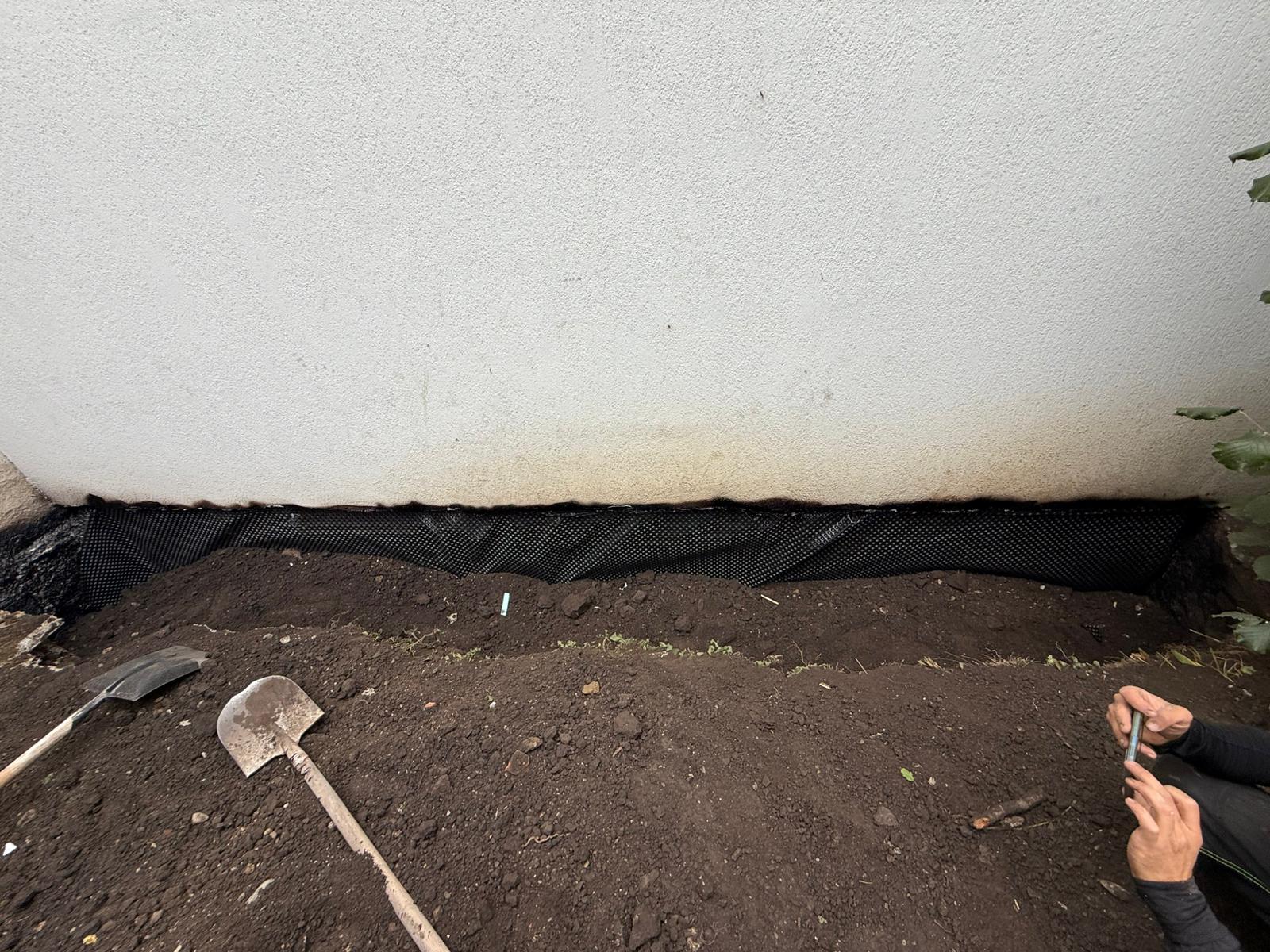 Foundation protected with waterproofing and membrane before backfilling